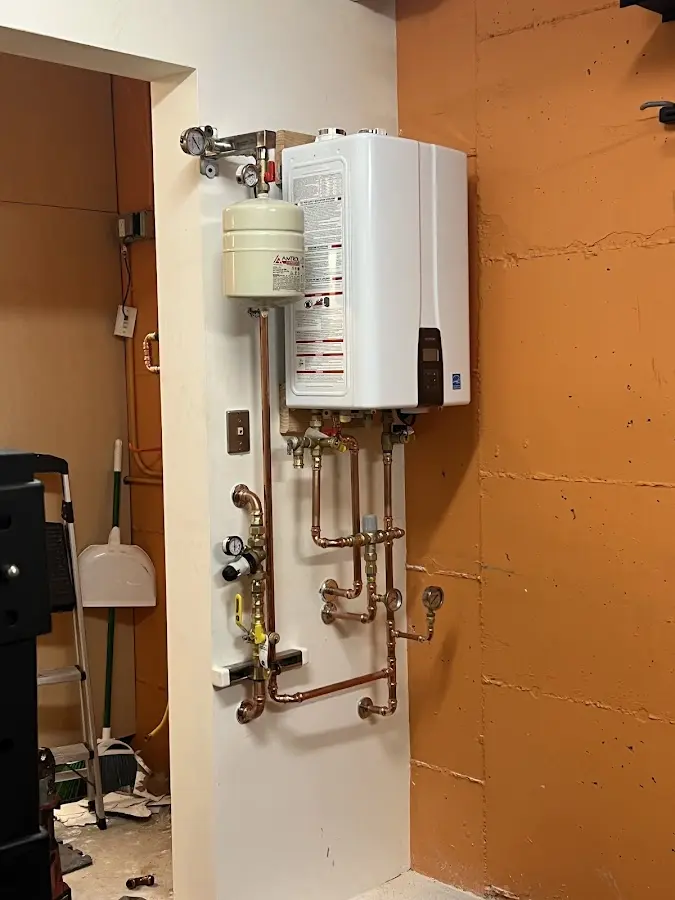 Plumbing technician inspecting water heater connections in Texas City